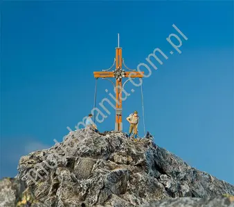Krzyż na szczycie góry i 2 figurki ludzi